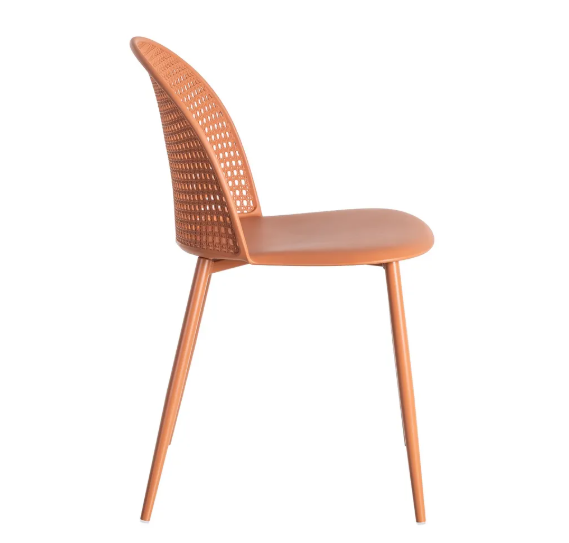 Silla color teja fabricada en polipropileno con respaldo calado y patas metálicas sobre fondo blanco