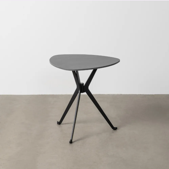 Mesa de centro color negro con sobre de piedra sinterizada y patas metálicas sobre suelo gris